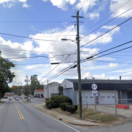 a street with power lines and cars on it